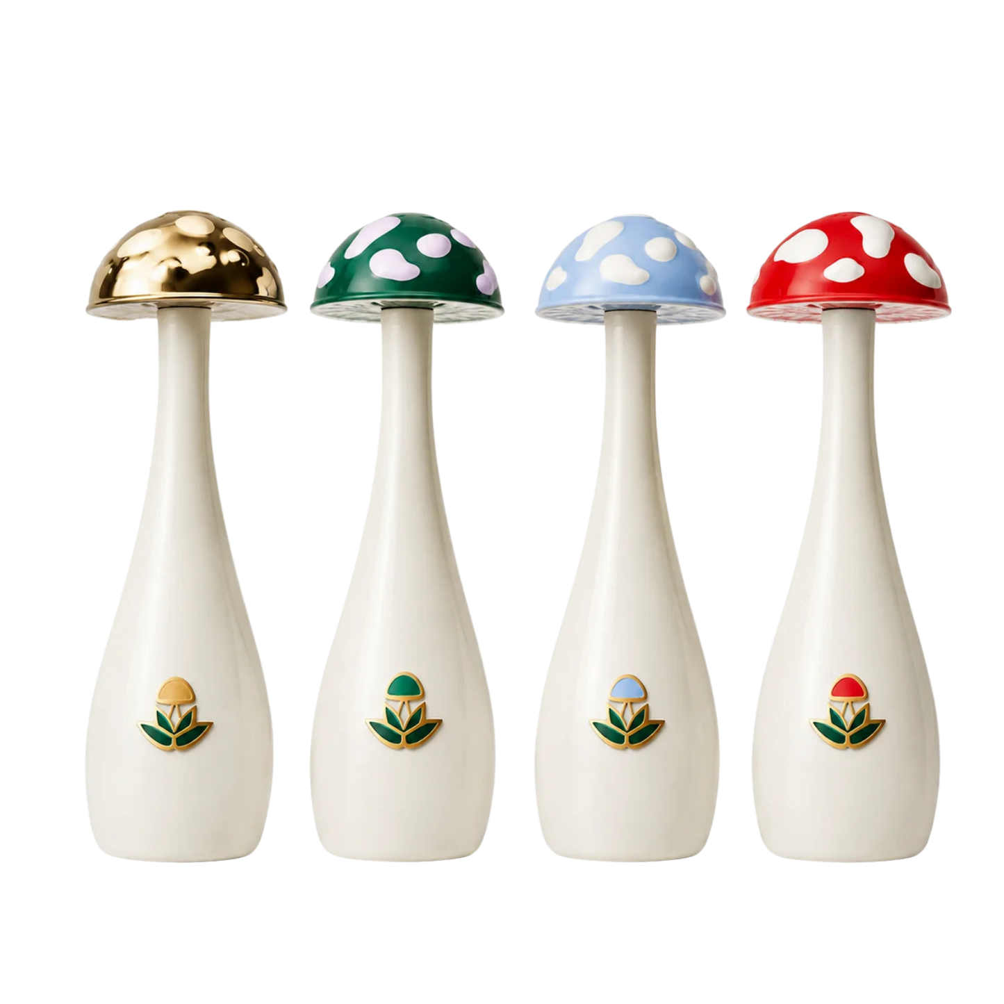 Four mushroom-shaped tequila by side on a white background. Each atomizer has a cream-colored body, a colorful mushroom cap (gold, green, light blue, and red with white spots), and a small matching floral emblem near the base.